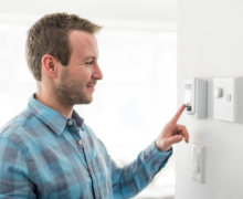 Man adjusting thermostat